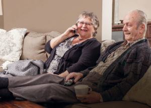 Couple using their television package to listen to a series 